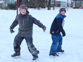 Dominic Jodouin, on left, was skating on Tuesday with his step-brother Colson Belisle, enjoying the outdoors and getting some exercise at the skating path in Hollinger Park.

RICHA BHOSALE/The Daily Press