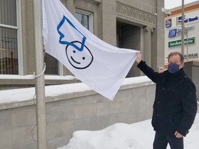 Timmins Mayor George Pirie raising the Bell Let's Talk Day flag at city hall.

Supplied