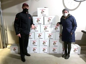 Tillsonburg Rapid Relief Team's Roland Shaw, left, presents 25 Christmas food boxes to Abbie Boesterd, Oxford County Community Health Centre outreach worker, to be distributed in the community Dec. 23-24. (Contributed photo)