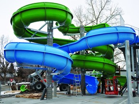 The new water slides for the new swimming pool have now been installed. Here, Andrew Clark of Versatile Waterpark Installations and sister Tracy do some work on the slides Jan. 13. Tracy Clark said some local kids were excited to see the slides go up.  STEPHEN TIPPER