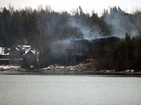 A recently sold multi-million dollar home smoulders on the shores of Georgian Bay west of Thornbury near the Lora Bay Golf Club hours after it was fully engulfed by fire early Monday morning. Greg Cowan/The Sun Times