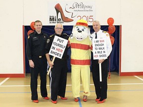 This 2015 Walk A Mile in Her Shoes photo features members from the local fire department.