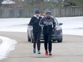 George Papadakos, with his son Zan, completes the final kilometres of his Marathons for Memories on Sunday, Jan. 31. In total, Papadakos ran 15 marthons in 31 days and raised more than $36,000 for the Alzheimer Society of Oxford. (Chris Abbott/Postmedia News)