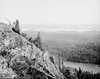 This 1906 photo, which appeared in the Detroit Press, shows an individual atop Mount Arabella, looking toward McGregor Bay and Manitoulin Island. Both Arabella and part of Mount Ararat lie within the 1,984-acre property that will be set aside as a conservation reserve if the Escarpment Biosphere Conservancy achieves its goal of purchasing the land.