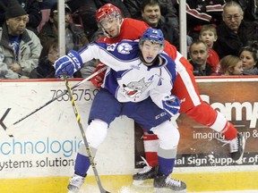 Former Soo Greyhounds defenceman Tony DeAngelo (rear) takes a hip check from Sudbury Wolves defenceman Kyle Capobianco during February 2015 play in Sault Ste. Marie. The New York Rangers placed DeAngelo on waivers after a reported incident with a teammate. JEFFREY OUGLER/POSTMEDIA