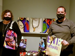 Gallery Stratford has partnered with Stratford’s Tall Man Promo to create unique tote bags made from recycled banners from the art gallery’s past exhibitions. Pictured, Gallery Stratford director/curator Angela Brayham and Tallman owner J. Oosterom show off some of the bags now available for purchase at $25 apiece. Galen Simmons/The Beacon Herald/Postmedia Network
