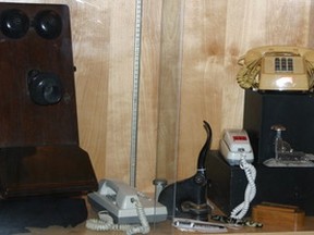 IMG_1804 – Like everything, evolution is not only part of history – it is history. It is no different for communication – the ways and devices used to convey it. This photograph is of a few of the early telephones used in the area, along with some other office essentials seen in a Peace River Museum, Archives and Mackenzie Centre display of a few years ago