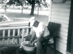 Bill Vye, Pickle Maker. Bill Vye scrubbing a bucket of cucumbers on the front porch of 15 Huron St., the house that used to stand at the northeast corner of Huron and Wallace streets. Photo submitted by Joyce Ritchie