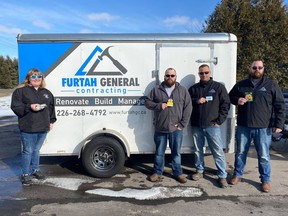 Elyssa Turner stands with Furtah General Contracting employees, Jesse, Mike, and Davey as they share their donation to her drive. Pam Turner photo