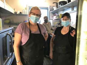 Jayne Curtis and Joanne Chitty of the Gananoque Curling Club and an unidentified helper working on food preparation for Thursday Night Take Out.  
Supplied by Joanne Lancaster