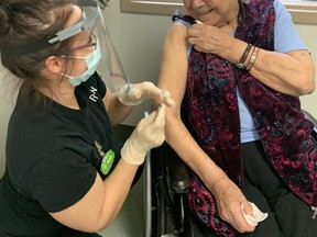 Lorraine Cada receives her COVID-19 vaccine from registered practical nurse Kaylina Beckerton. SUPPLIED