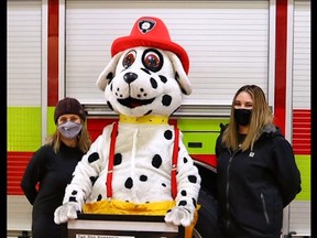 Christine Wales (left) and Alyssa Deans (right) donated one pet oxygen mask to the Fort Saskatchewan Fire Department, and the department purchased a second mask this week to support The Dog Shoppe's pet mask initiative.
(Photos courtesy Al Speer)