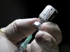 COVID-19 vaccine manufacturers should not be ‘holding the world over a barrel.’ CARLOS OSORIO/AFP via Getty Images
