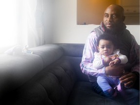 Peter Oladipo and his daughter, four-month-old Joanna, at their home on Saturday, Feb. 13, 2021.