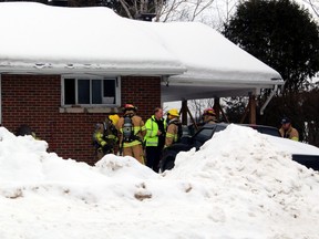 Firefighters confer outside the scene of a fire on Cedargrove Drive in North Bay, Sunday afternoon. No injuries were reported in the blaze which started in the kitchen.
PJ Wilson/The Nugget