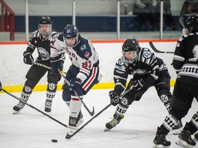 French River Rapids forward Levi Siau (93) is defended by a group of Espanola Express players during NOJHL action on November 28, 2020.