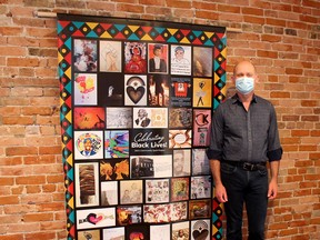 Thames Art Gallery curator Phil Vanderwall displays the Celebrating Black Lives: Community Quilt Project, comprising of artwork by 35 participants. The quilt is on public display at ARTspace's Window Gallery throughout Black History Month. Ellwood Shreve/Postmedia Network