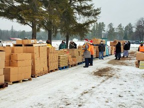 More than 80 volunteers distributed free food from dozens of skids at the first giveaway at the Massey fairgrounds.