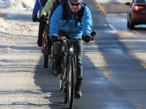 Andre Riopel leads cyclists along a designated bike lane on Queen Street East in November 2014. He now wants to raise $150,000 for a bike trail in the Finn Hill area.BRIAN KELLY
