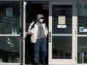 A man in a mask exits an AHS COVID-19 vaccination clinic in north Edmonton, on Wednesday, Feb. 24. IAN KUCERAK/Postmedia