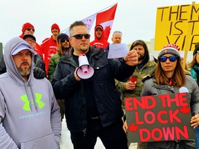 A crowd of 50 gathered at the corner of Clarence Street and Colborne Street East in Brantford Sunday to protest ongoing lockdown measures related to the COVID-19 pandemic. Airing his views with the aid of a bullhorn at centre was Jason Tompkin, of Brantford. – Monte Sonnenberg