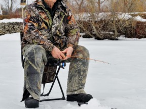 Rick Norman of Renton enjoys ice fishing at the Waterford North Conservation Area Sunday. Norman says it’s great to be outside at the ponds even if he heads home at the end of the day with nothing to show for his efforts. – Monte Sonnenberg