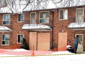 The ground-level unit in this Mitchell apartment building – the site of a Feb. 11 fire that sent two people to hospital – has been boarded up while contractors were seen knocking on neighbours’ doors Feb. 19. A 27-year-old man who neighbours say was temporarily living in the unit has been charged with attempted murder and arson in connection to the fire. 
GALEN SIMMONS