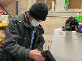 An unidentified person uses the laundry facilities at Chatham Hope Haven.