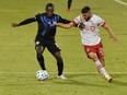 Montreal Impact defender Zachary Brault-Guillard (15) plays the ball and Toronto FC midfielder Jonathan Osorio (21) defends during the first half at Stade Saputo on Aug. 28, 2020.