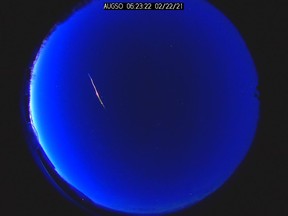 A meteor streaks across the morning sky in Edmonton, AB on Monday Feb.22, 2021.