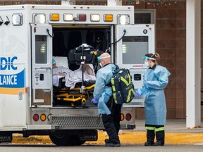 Paramedics transport a person from Roberta Place, a long-term seniors care facility which is the site of a coronavirus disease (COVID-19) outbreak, in Barrie, Jan. 18.  
REUTERS/Carlos Osorio