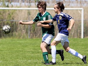Brayden Boere, left, of St. Patrick's and Billy Giannikos of East York chase the ball in the second half of a pool game in the OFSAA boys' AAA soccer championship at the Veteran's Memorial Fields in Sarnia, Ont., on Friday, June 7, 2019. Mark Malone/Chatham Daily News/Postmedia Network