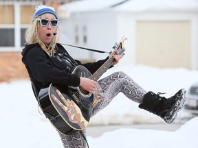Ray Stern, of The Universe Featuring Ray, performs outside a home on Elizabeth Street in Chatham, Ont., on Sunday, Feb. 21, 2021. (Mark Malone/Chatham Daily News)