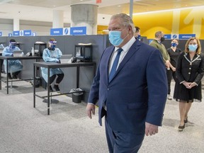 Ontario Premier Doug Ford walks through the COVID-19 testing centre in the International Arrivals section at Pearson Airport in Toronto on January 26, 2021.