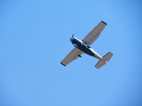 A small airplane flies during a clear blue day. File photo