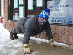 Stacy Fenwick wraps up his 25 pushups for 25 days challenge for mental health awareness by doing the pushups at the Canadian Mental Health Association Grey Bruce office in downtown Owen Sound. DENIS LANGLOIS