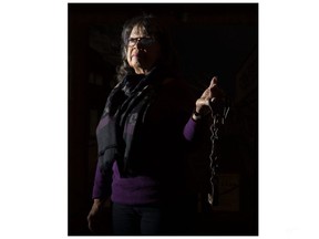 Shannon Prince, curator of the Buxton National Historic Site and Museum in the Chatham-Kent community of Merlin, holds iron shackles that were once used on slaves. Photo shot on Wednesday February 10, 2021. (Derek Ruttan/The London Free Press)