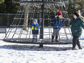 Melissa Sherman spins her sons Isaac (5) and Finley (2) on the carousel at Pinafore Park in St. Thomas on Sunday. "We're trying to get our energy out," quipped Isaac. (Derek Ruttan/The London Free Press)