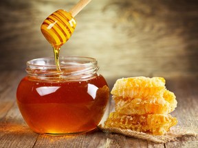 jar of honey with honeycomb