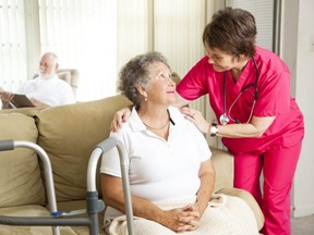 A PSW cares for a patient. (Postmedia file photo)