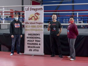 From left to right, trainers Anthony Palombo, Luis Cofre, and Vanessa Bellagarde pose in the empty Airdrie Martial Arts Centre. The fitness studio has endured months of closures due to COVID-19. Photo by Kelsey Yates