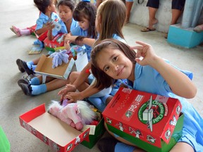 In Costa Rica, children eagerly open the shoeboxes from Operation Christmas Child. Photo by Frank King