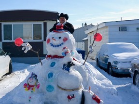 Airdrie resident Bryan Stote has been taking advantage of the chilly weather to craft some snowmen in his front yard. He said he was happy to do it to bring smiles to his neighbours. Photo by Kelsey Yates