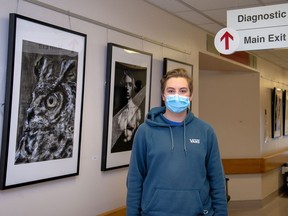 Jackson Dierickse stands with some of his art work on display in the hallway at the Canmore Hospital. photo by Pam Doyle/www.pamdoylephoto.com