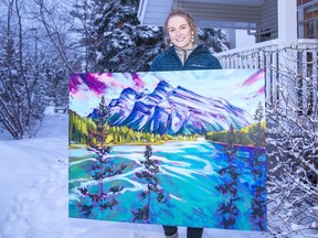 Canmore artist Kayla Eykelboom holds her painting of Mount Rundle and Two Jack Lake called 'Rocky Hypnosis'. The acrylic on canvas piece is 36 x 48 inches and available at the Avens Gallery in Canmore. photo by Pam Doyle/www.pamdoylephoto.com