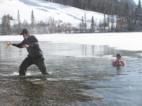 Freezin' for a reason. Kananaskis District Conservation Officers Arthur Hughes and Dan Neath, and their friend Anne Kokko braved the cold water and -20 temperatures at Goat Pond on Feb.13. This year the Polar Plunge took place virtual, and marked the 10th year of the annual Law Enforcement Torch Run Polar Plunge in support of Special Olympics Alberta. Photo Marie Conboy/ Postmedia.