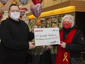 John Burke from Belleville's Metro grocery store recently presented a cheque for $5,174.83 to Susanne Quinlan, Director of Operations for Gleaner's Food Bank. BRAD DENOON PHOTO