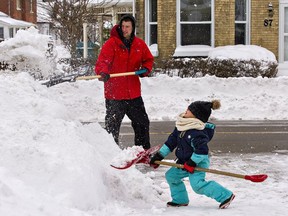 Greg Belisle gets help shoveling snow on Tuesday morning from his six-year-old daughter, Braylynn. The area was blanketed with about 15 cm of powder snow overnight, including here in the Terrace Hill neighbourhood of Brantford. Brian Thompson