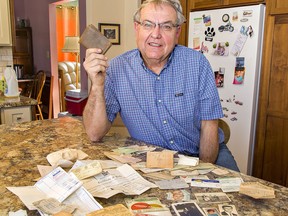 Ken Mercer of Cainsville shows his father's wallet -- and its myriad of contents -- that was lost 47 years ago in Hamilton, and returned after a contractor discovered it behind bricks in the basement of a Hamilton home under renovation.