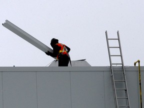 A worker carries a beam on the roof of the Brockville 3M facility being built to produce N95 masks, which remains under construction, on Thursday afternoon, Feb. 18. (RONALD ZAJAC/The Recorder and Times)